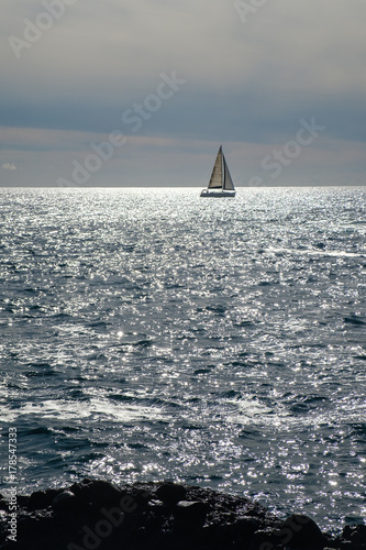sail boat at horizon line