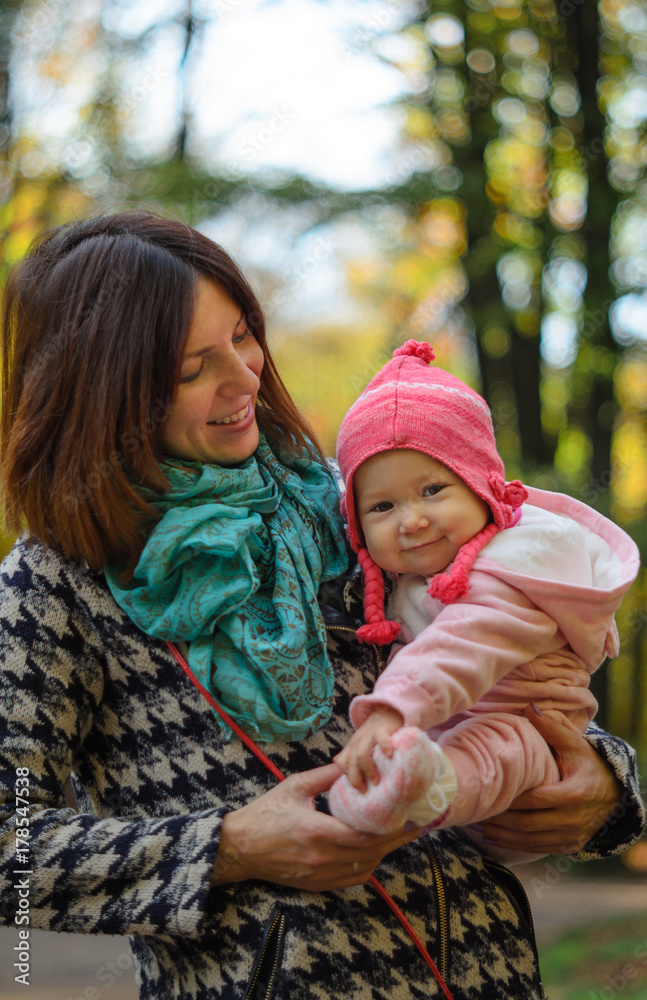 Happy family: mother and child little daughter in nature outdoors