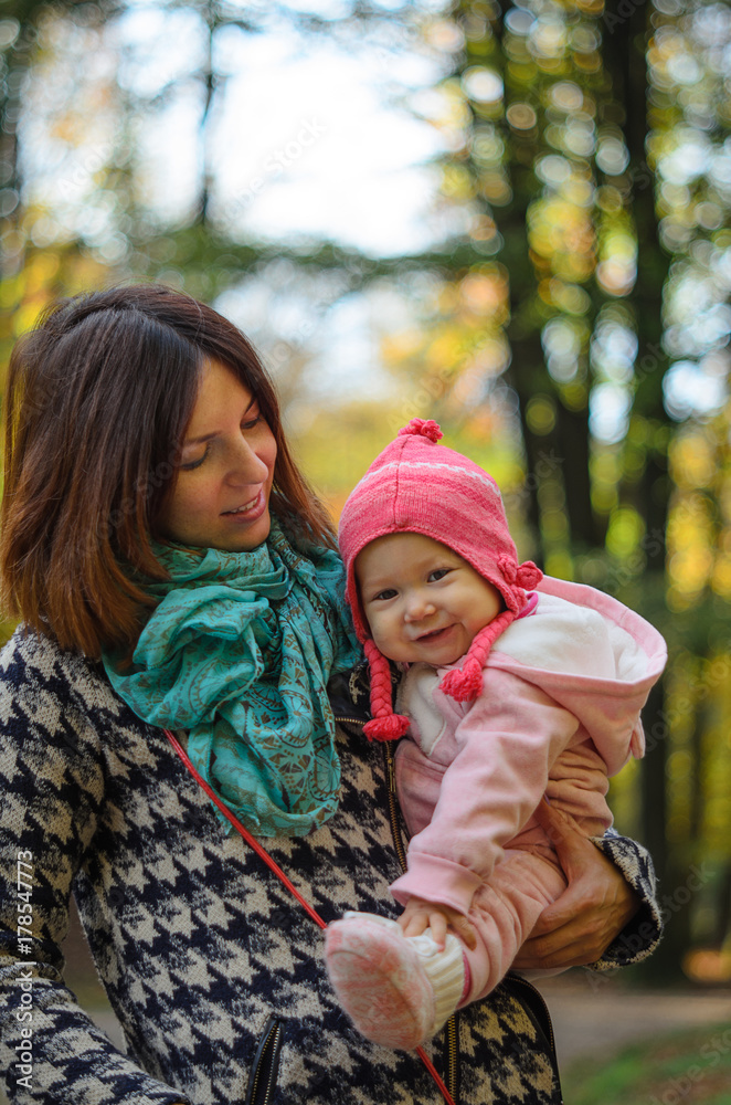 Happy family: mother and child little daughter in nature outdoors