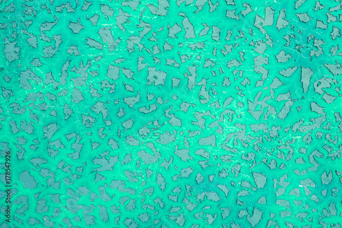 Green peeling paint on the metal surface texture background