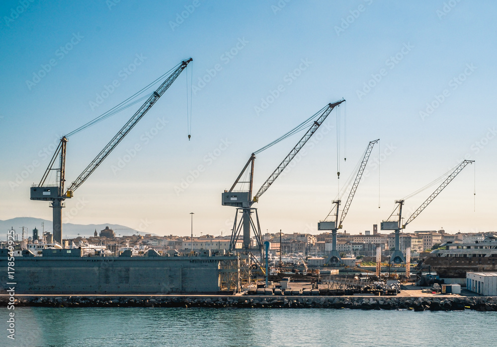 cranes and shipyards in Livorno harbor. Tuscany, Italy.