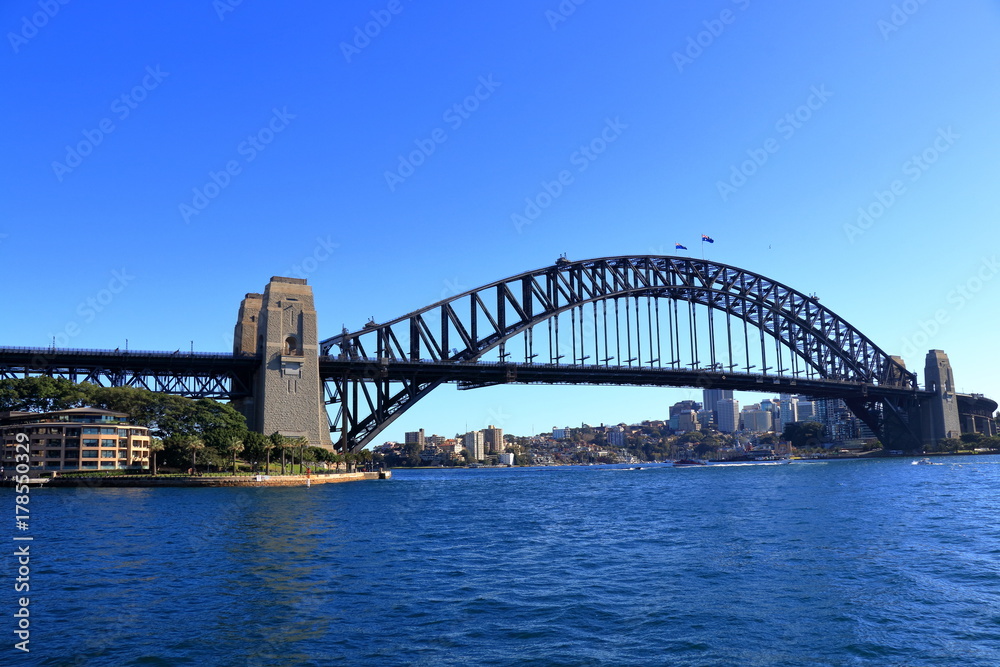 Sydney Harbour Bridge view from a ferry with stunning blue sky