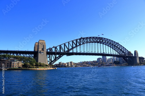 Sydney Harbour Bridge view from a ferry with stunning blue sky