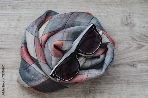 Composition, stylish women's glasses and fashionable multi-colored scarf (stole).