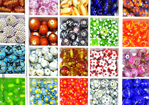 Brightly coloured Lampwork glass beads in a tray