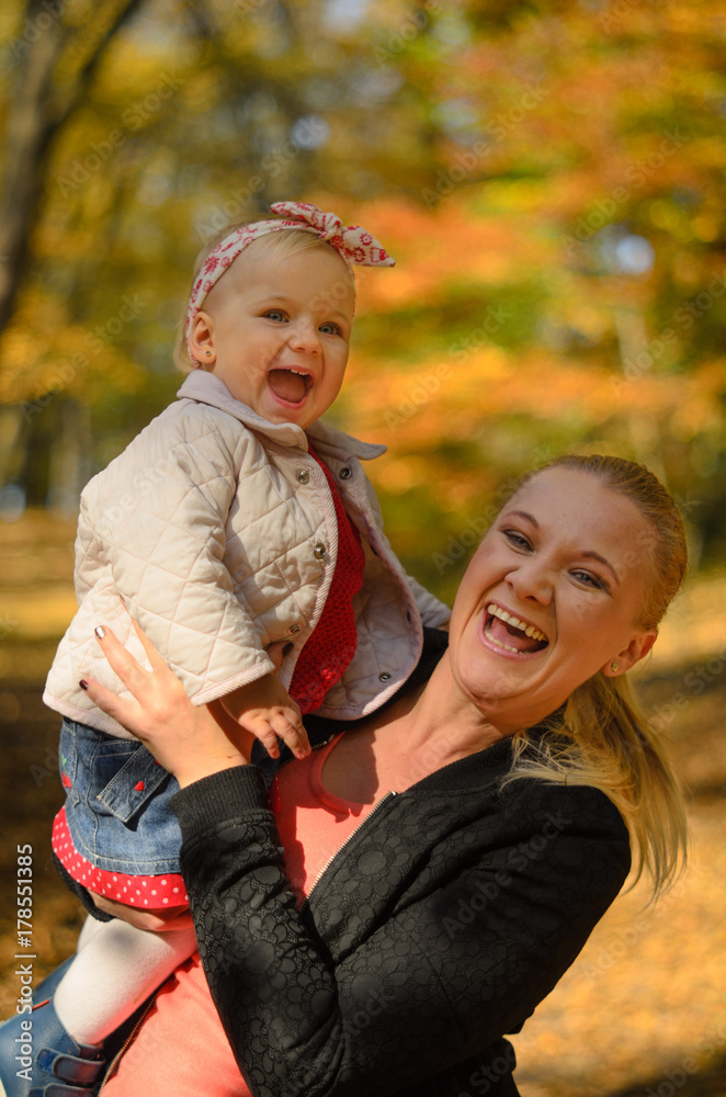 Happy baby laughing out loud with her mother