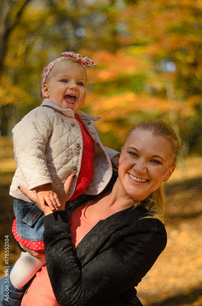 Happy baby laughing out loud with her mother