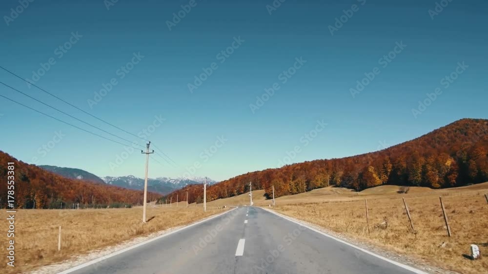 Driving on a road in autumn mountains
Driving on a road in autumn mountains
