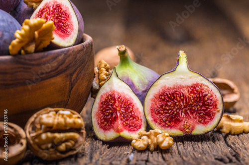 Figs and walnuts.. A few figs and walnuts in a bowl on an old wooden background