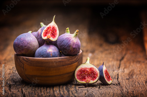 Figs. A few figs in a bowl on an old wooden background photo