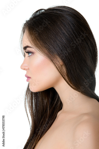 Gorgeous girl's profile, studio shot isolated on white background. Beautiful young woman's portrait.