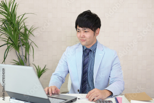 ノートパソコンで仕事中のビジネスマン