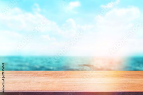 Wood table top on blur sea background. Summer, nature concepts. For montage product display or design key visual layout. © vanderon
