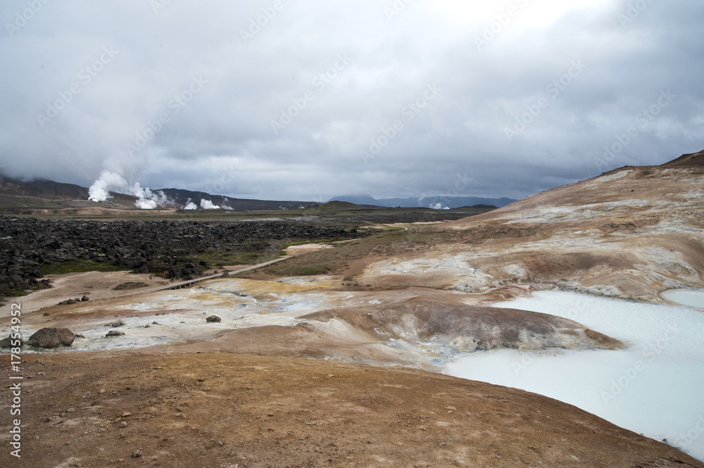 Hverarönd, Iceland. Hot vapors in a typical Icelandic landscape, a wild nature of rocks and shrubs, rivers and lakes.
