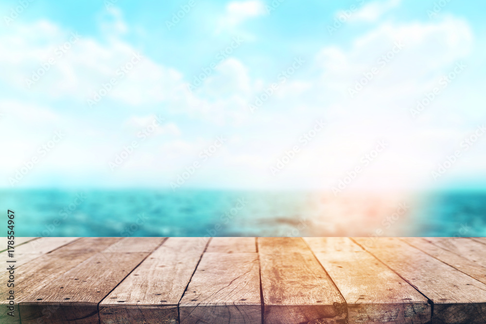 Wood table top on blur sea background. Summer, nature concepts. For montage product display or design key visual layout. Wood table top on blur sea background. Summer, nature concepts. For montage product display or design key visual layout.