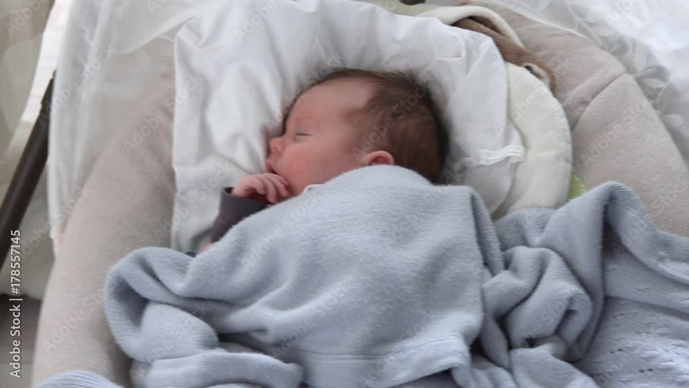 Cute newborn baby sleeping in swinging cradle Cute newborn baby sleeping in swinging cradle