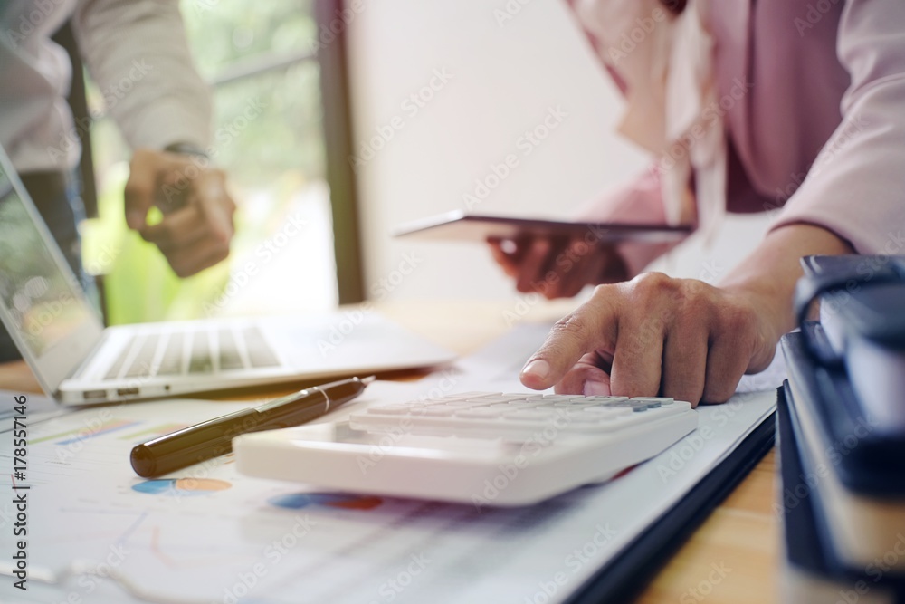 Accountant verify the business and saving money stacking gold coins with calculator. Accountancy Concept Accountant verify the business and saving money stacking gold coins with calculator. Accountancy Concept