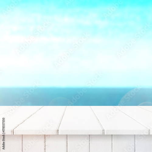 Wood table top on blur sea background. Summer, nature concepts. For montage product display or design key visual layout.