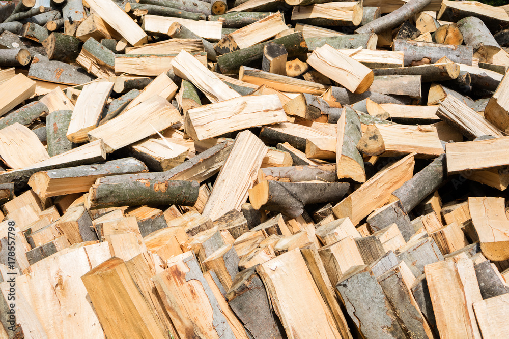 Firewood texture. Stacked firewood heap. Dry chopped firewood logs Firewood texture. Stacked firewood heap. Dry chopped firewood logs