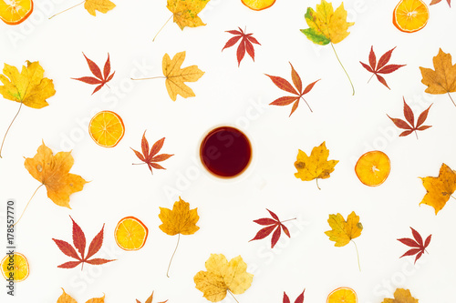 Autumn colorful maple leaves and tea cup on white background. Flat lay  top view.