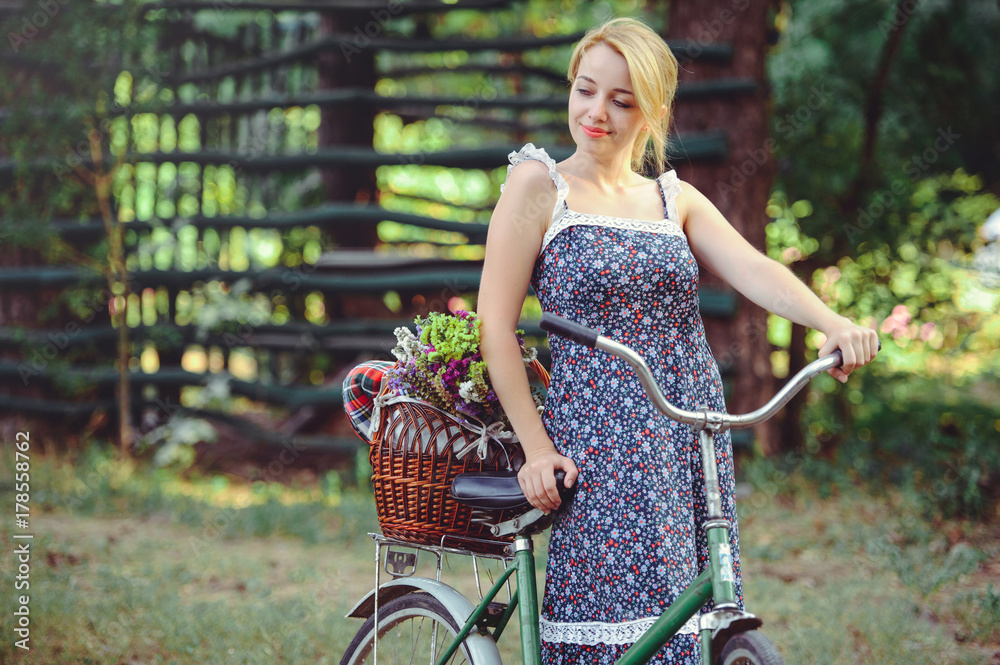 A healthy woman. Beauty Summer model girl with bright colors bicycle forest  and basket. style leisure. A beautiful lady with blond hair. Cute face.  Cosmetic makeup fashion Stock Photo | Adobe Stock