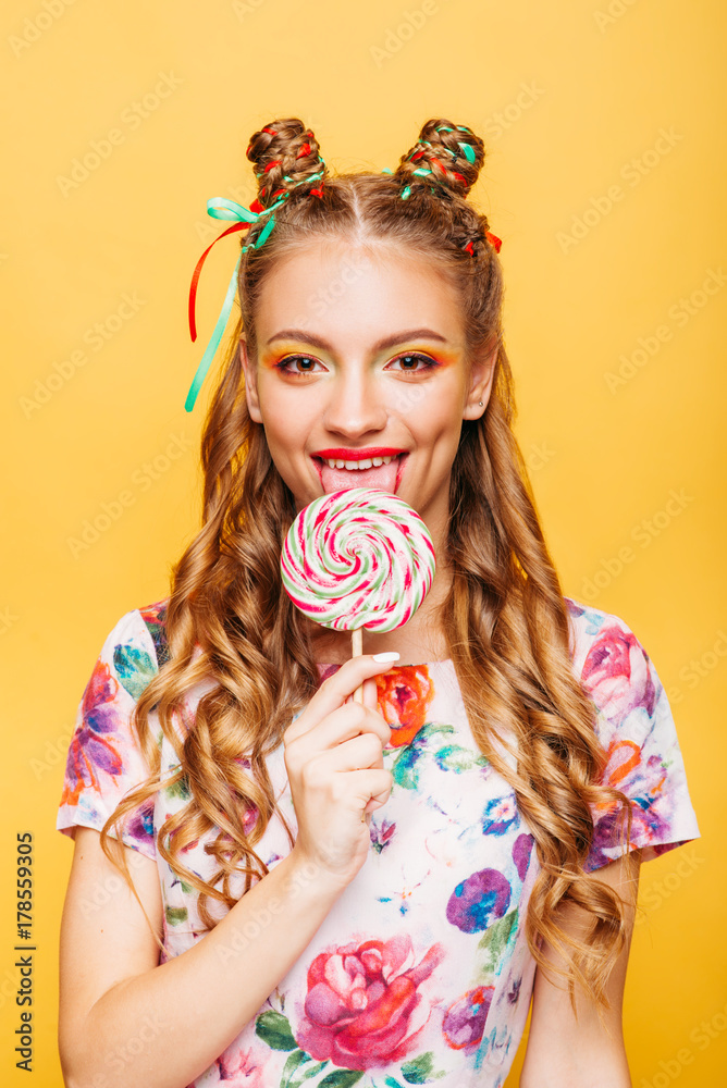 Woman with playful look lick candy with tongue Woman with playful look lick candy with tongue