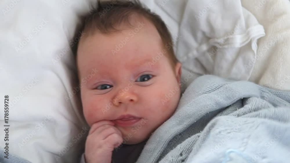 Cute newborn baby in crib, close-up Cute newborn baby in crib, close-up
