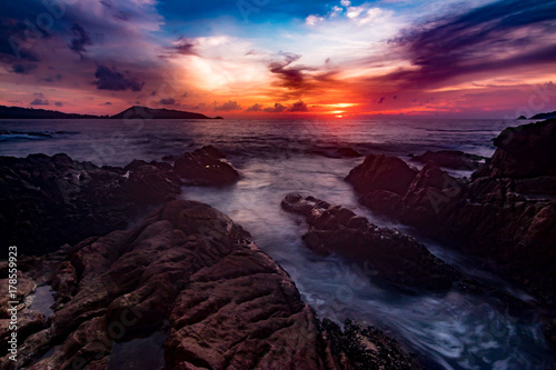 Seascape landscape nature in twilight and rock with colorful of sunset over the sun, Beach Sea, Sunset Sunlight or Sunrise, Twilight Sky Scenic with Sun Silhouette.