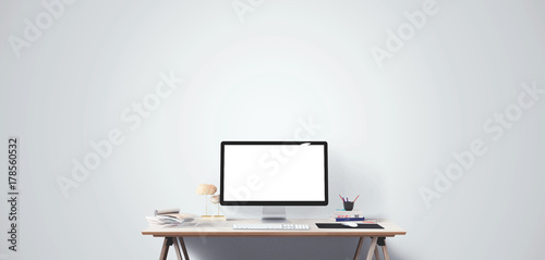 Computer display and office tools on desk. Desktop computer screen isolated. Modern creative workspace. Front view.