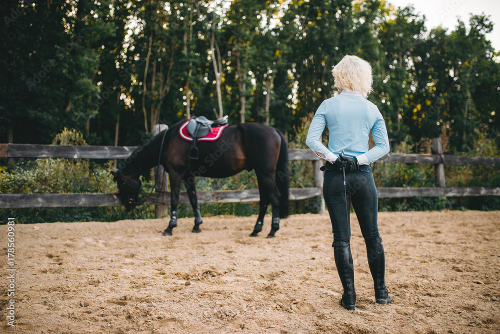 Female rider trains her horse, horseback riding Female rider trains her horse, horseback riding