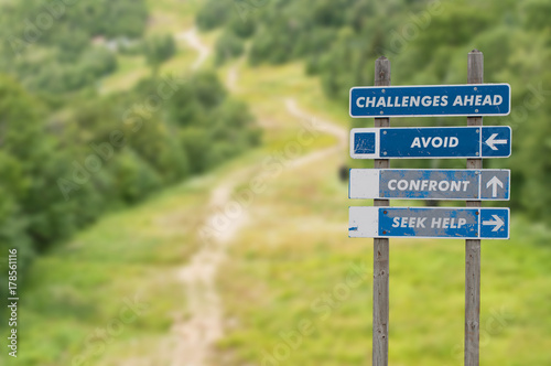Signpost on top of the mountain warning challenges ahead and three options