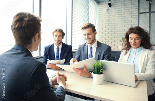 Job interview with the employer, businessman listen to candidate answers. photo