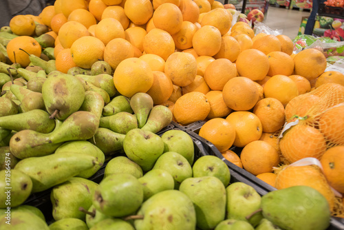 pears and oranges close-up on the market photo