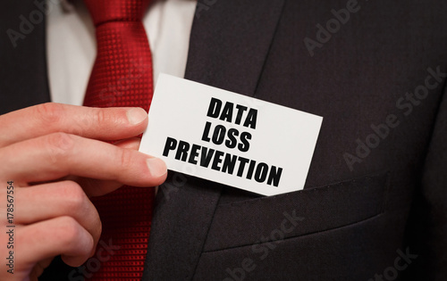 Businessman putting a card with text Data Loss Prevention in the pocket photo