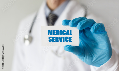 Doctor holding a card with text Medical Service,medical concept
