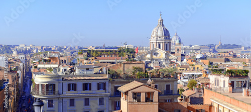 Panorama Cityscape with elevated view of city and commercial and residential buildings with tile rooftops in Rome, Italy