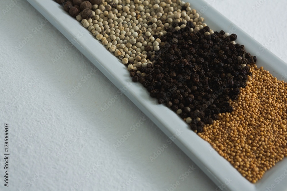 Various spices in tray on white background Various spices in tray on white background