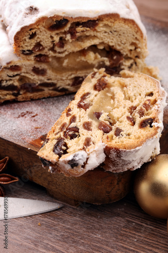 Christmas stollen on wooden cutting board. Traditional German festive baking