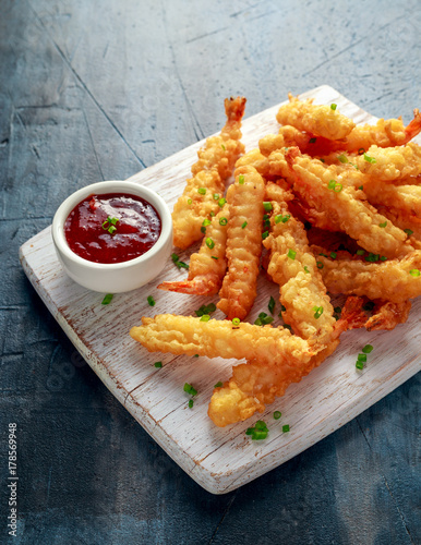 Fried Shrimps tempura with sweet chili sauce on white wooden board