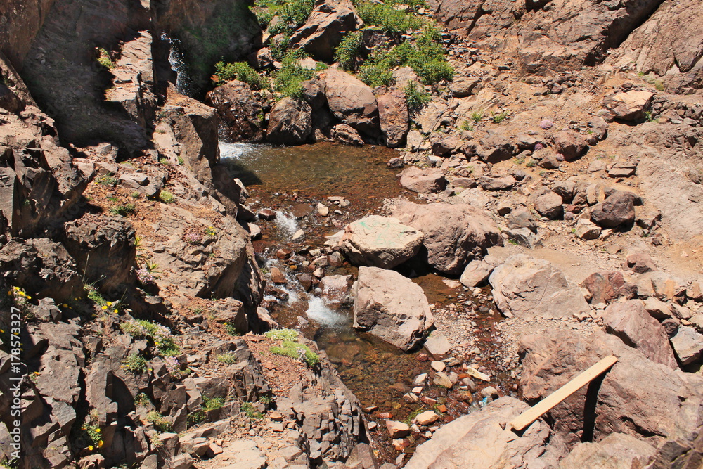 Small waterfall in Atlas mountains in Morocco. Trekking on Toubkal - the highest peak in Morocco, Small waterfall in Atlas mountains in Morocco. Trekking on Toubkal - the highest peak in Morocco,