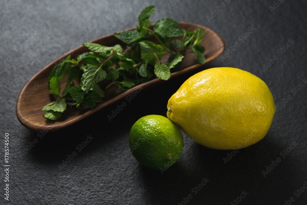 Mint leaf and sweet limes on black background