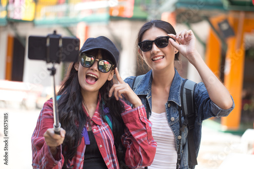 Portrait of Happy traveler Woman Selfie with friend together in city. Asian women using Smartphone with Happy emotions, Woman with Travel Concept.