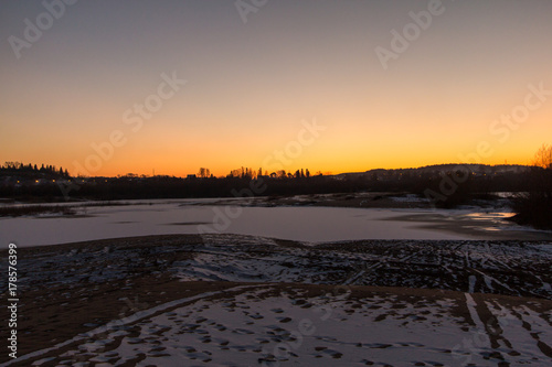 frozen lake at sunset © Dmitrii