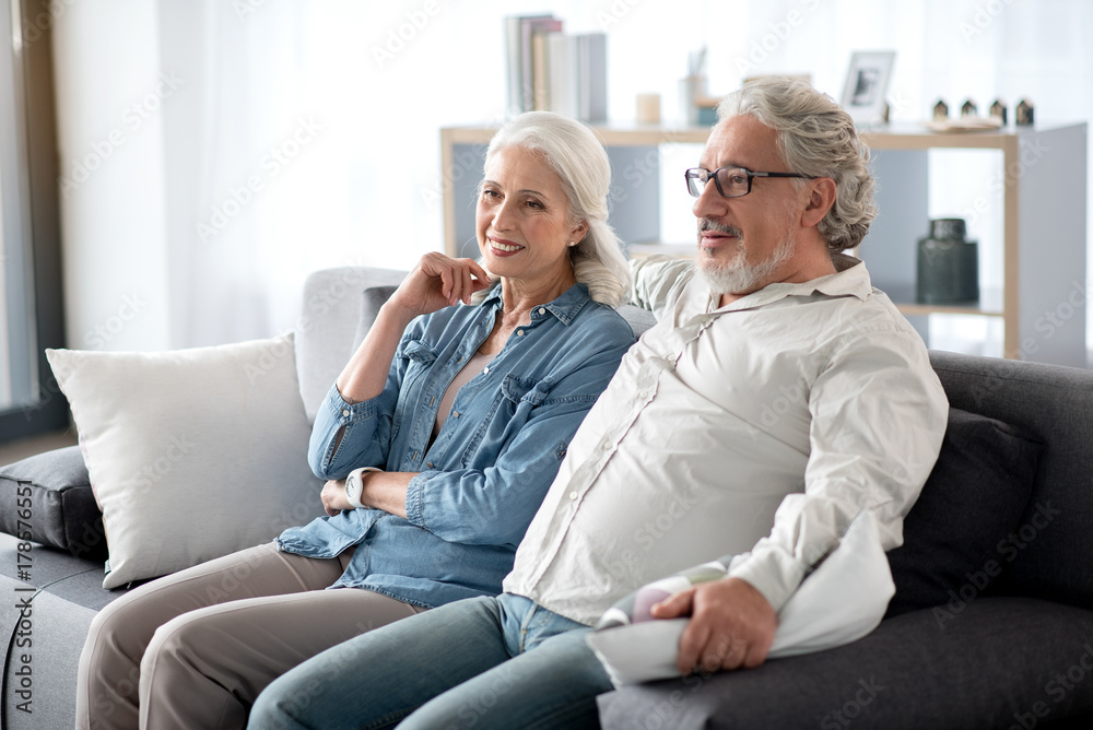 Happy husband and wife entertaining in living room Happy husband and wife entertaining in living room