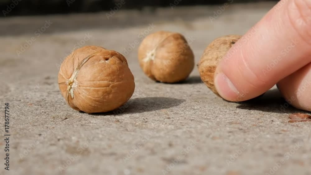 Walnut cracking with a hammer, hands. Cracking A Walnut With Hammer.