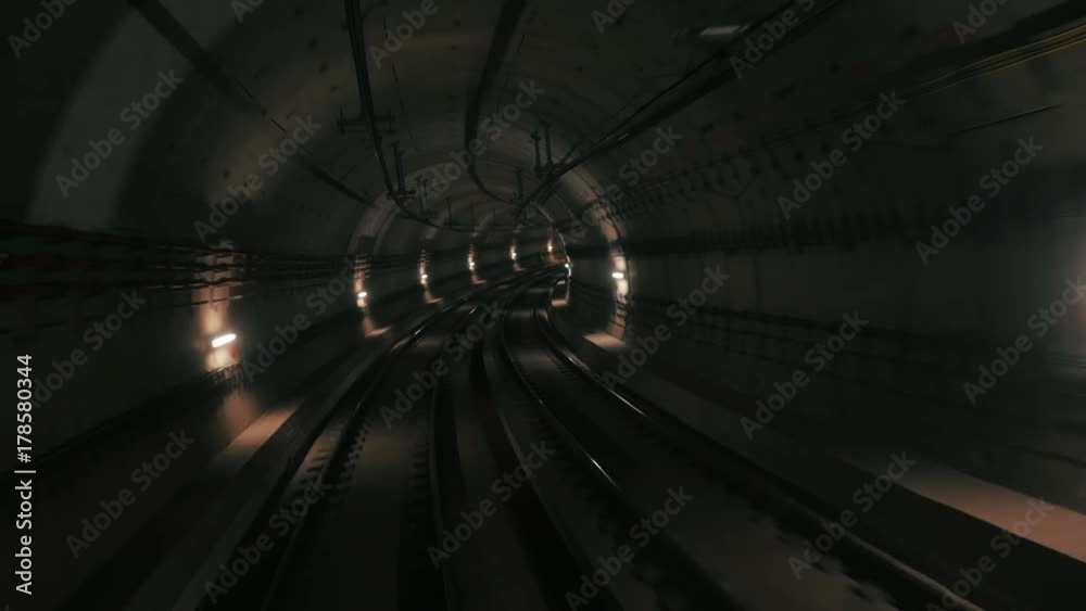 View of subway tunnel as seen from reverse of moving backward train. Fast underground train riding in tunnel of modern city.Long footage of underground train following its route