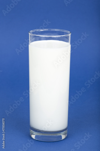 Glass of milk on a blue background
