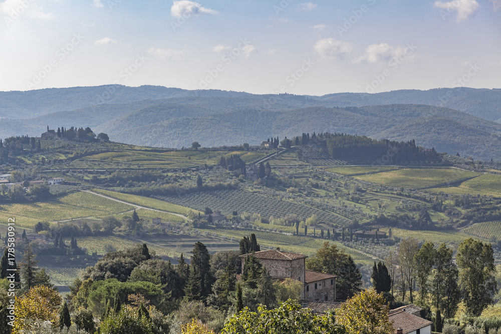 View over old stone house to hills with vineyards near Chastellina in Chianti in Tuscany