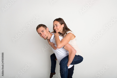 Loving couple, man piggybacking girlfriend