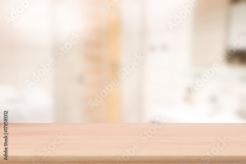 Wood table top with blur bathroom interior to promote your products